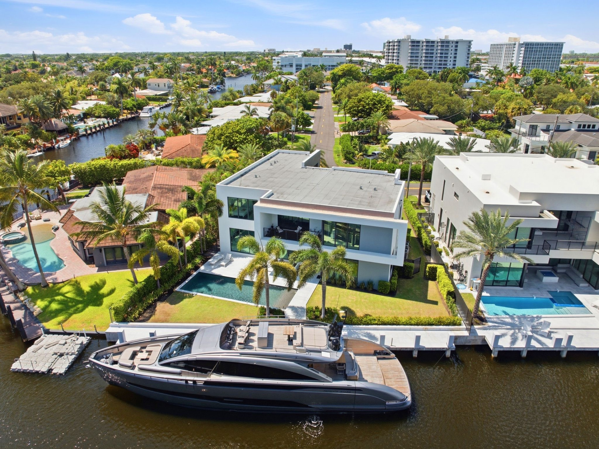 Aerial view of Casa Aqua's waterfront frontage and yacht alongside the concrete dock